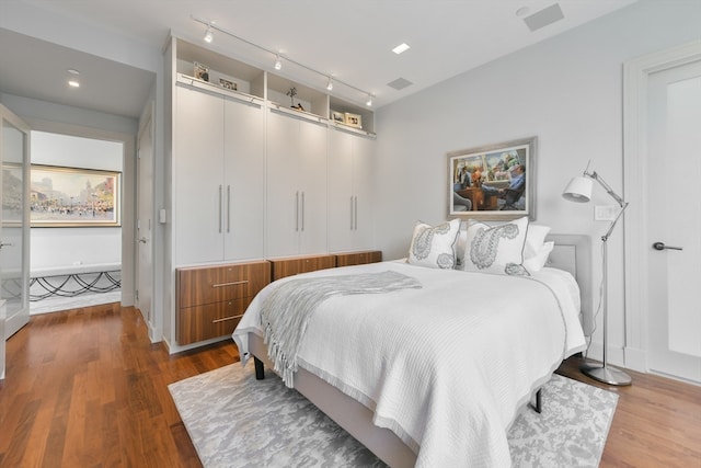 bedroom with hardwood / wood-style floors