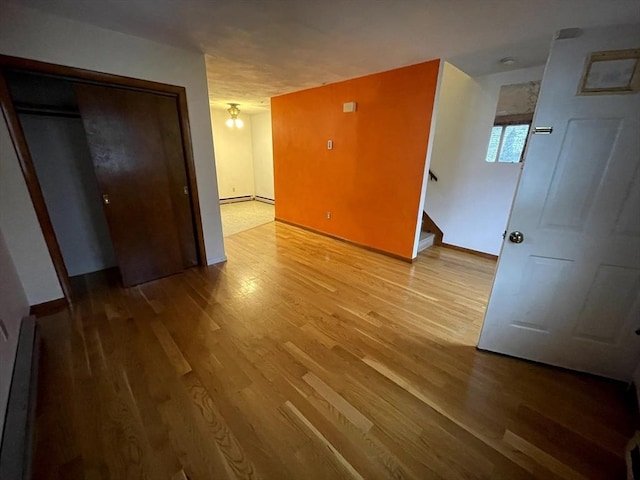 21 Hillside Ave Unit 21, Everett, MA 02149 - empty room featuring stairway, wood finished floors, and a baseboard radiator