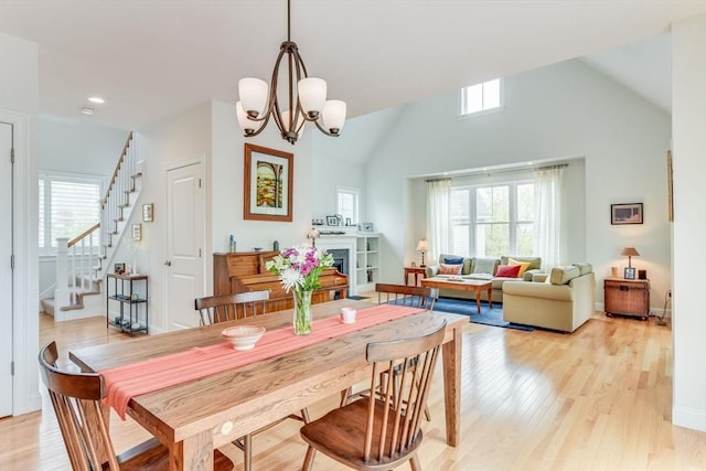 dining area featuring a wealth of natural light, a fireplace, and stairs