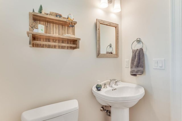 bathroom with toilet and a sink