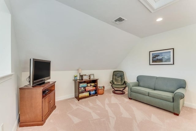 living area with recessed lighting, visible vents, light carpet, vaulted ceiling with skylight, and baseboards