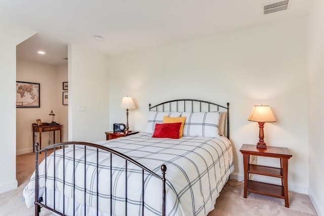 bedroom with recessed lighting, visible vents, light carpet, and baseboards