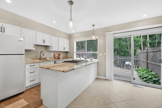 83 Jamestown Dr Unit 83, Springfield, MA 01108 - kitchen with freestanding refrigerator, a sink, white cabinets, light stone counters, and recessed lighting