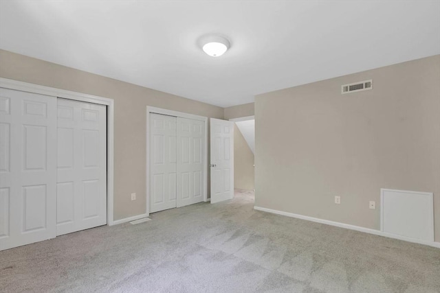 83 Jamestown Dr Unit 83, Springfield, MA 01108 - unfurnished bedroom featuring carpet, two closets, and baseboards