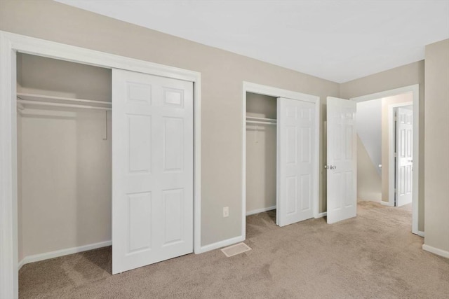 83 Jamestown Dr Unit 83, Springfield, MA 01108 - unfurnished bedroom with carpet, two closets, and baseboards