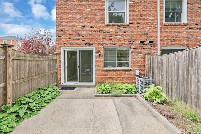 83 Jamestown Dr Unit 83, Springfield, MA 01108 - property entrance with a patio, cooling unit, and brick siding