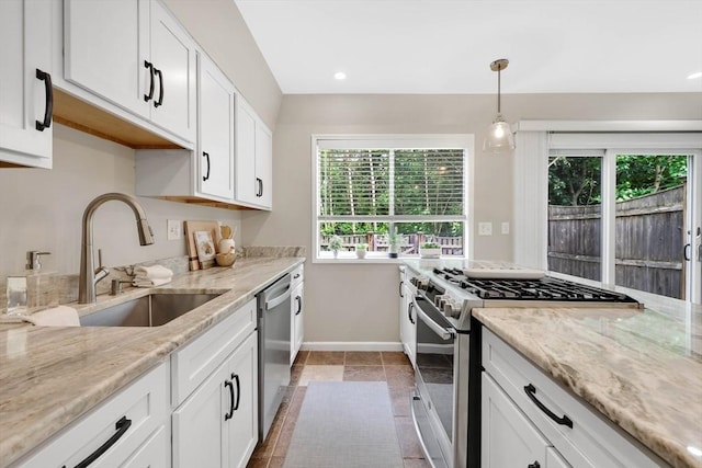 83 Jamestown Dr Unit 83, Springfield, MA 01108 - kitchen with appliances with stainless steel finishes, a sink, baseboards, light stone countertops, and white cabinets