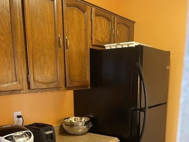 kitchen featuring black refrigerator