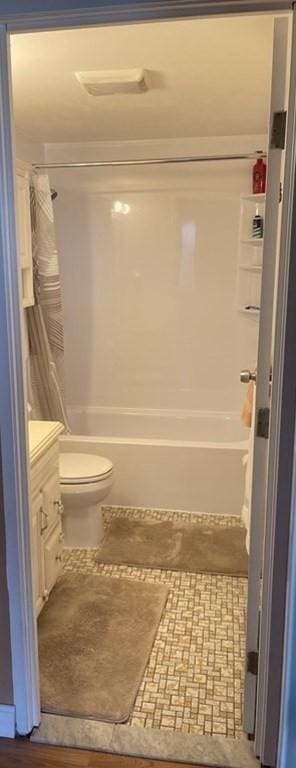 full bathroom with vanity, shower / bath combination with curtain, and toilet