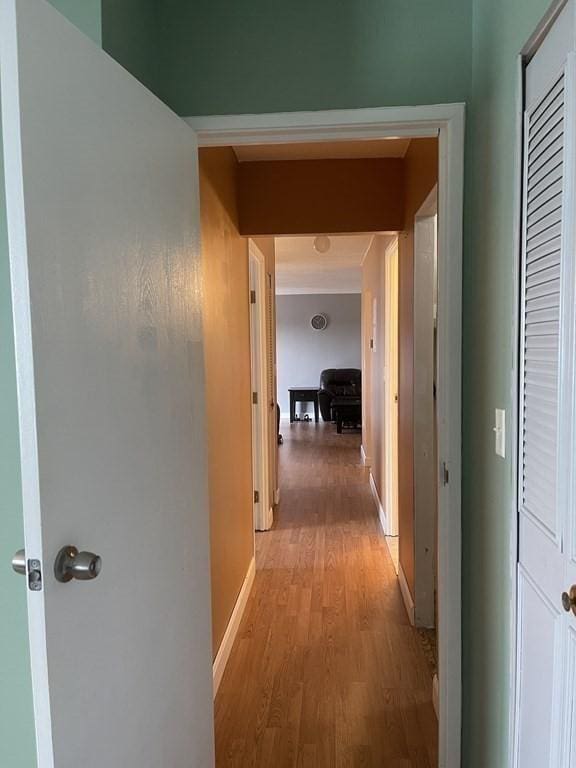 corridor with light hardwood / wood-style floors