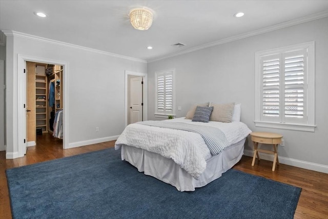 bedroom with crown molding, dark wood finished floors, visible vents, and baseboards