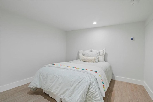 bedroom featuring recessed lighting, baseboards, and light wood finished floors