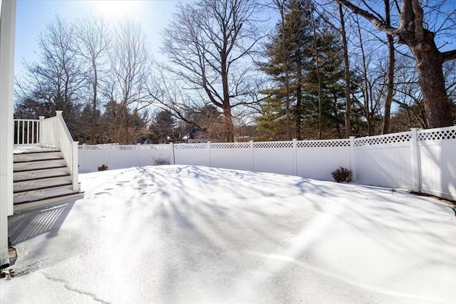 yard layered in snow with fence private yard and stairway