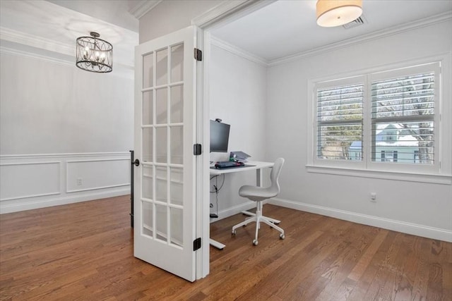 home office with ornamental molding, a chandelier, wood finished floors, and a decorative wall