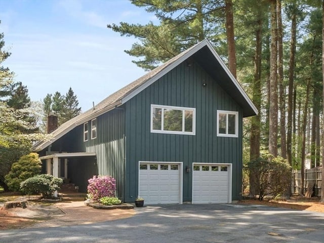 garage featuring aphalt driveway