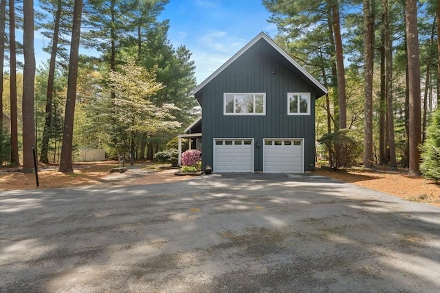 view of side of home with an attached garage and driveway