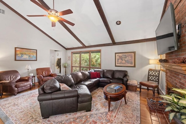 living room with wood finished floors, a ceiling fan, a fireplace, visible vents, and beamed ceiling