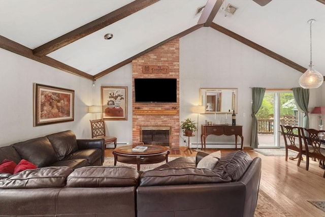 living area with beamed ceiling, baseboard heating, and light wood-type flooring