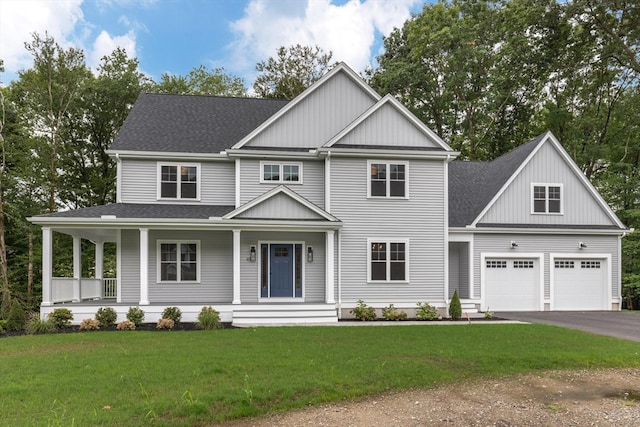 view of front facade featuring a porch, a garage, and a front yard