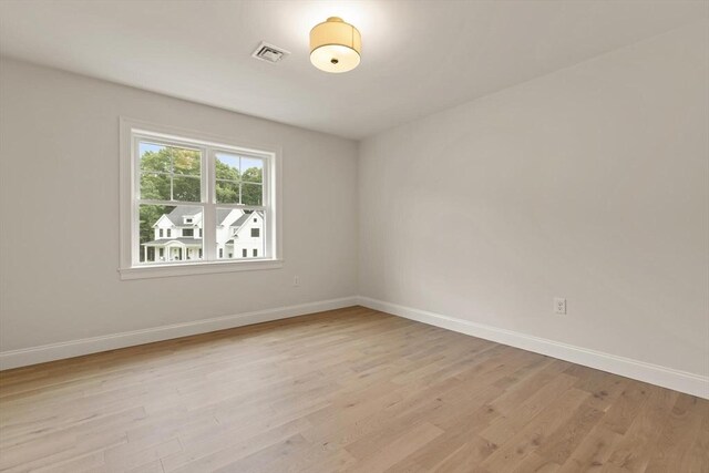 empty room with hardwood / wood-style flooring