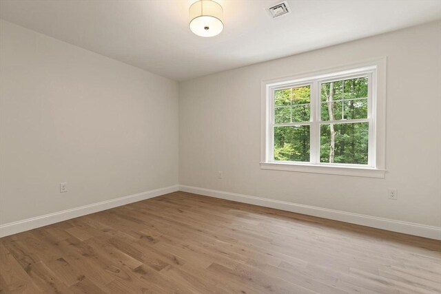 spare room with light wood-type flooring