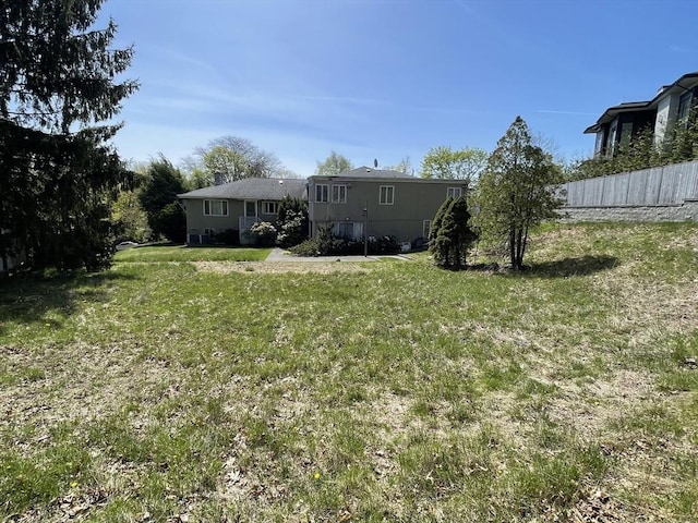 back of property with a lawn