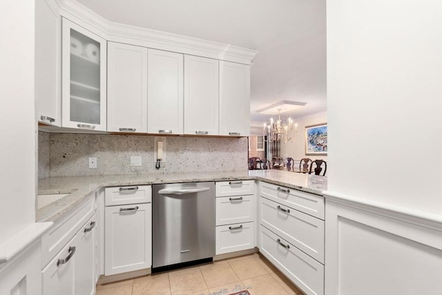 kitchen featuring light tile patterned flooring, backsplash, white cabinets, a chandelier, and stainless steel dishwasher