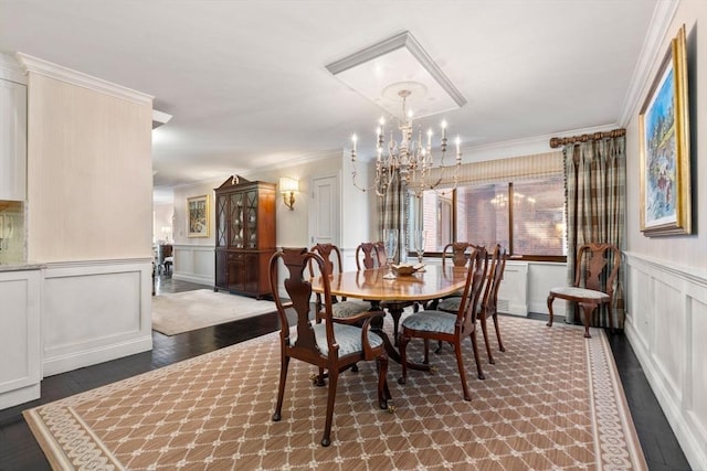 dining space featuring an inviting chandelier, dark wood-type flooring, and ornamental molding