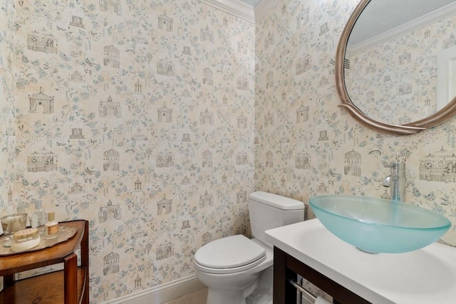 bathroom featuring vanity, crown molding, and toilet