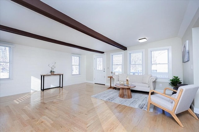 sitting room with beamed ceiling and light hardwood / wood-style floors