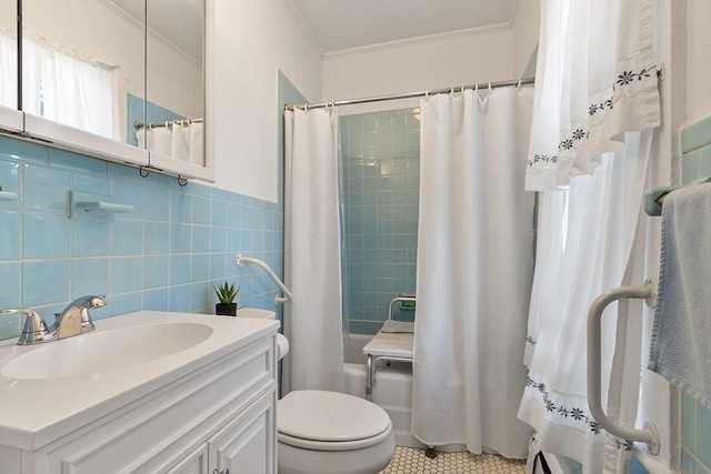 19 Franklin St, Wakefield, MA 01880 - bathroom with ornamental molding, shower / bath combo, vanity, tile patterned flooring, and tile walls
