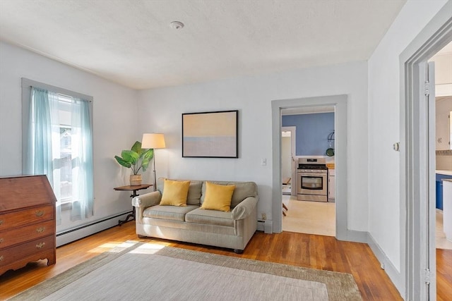 19 Franklin St, Wakefield, MA 01880 - living room with a baseboard radiator and wood finished floors