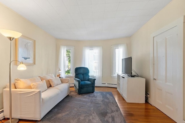 19 Franklin St, Wakefield, MA 01880 - living area with baseboard heating, wood finished floors, and a baseboard radiator
