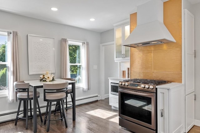 19 Franklin St, Wakefield, MA 01880 - kitchen with wall chimney range hood, appliances with stainless steel finishes, tasteful backsplash, white cabinetry, and recessed lighting