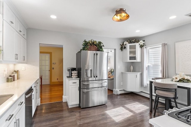 19 Franklin St, Wakefield, MA 01880 - kitchen featuring appliances with stainless steel finishes, dark wood finished floors, light countertops, backsplash, and white cabinets