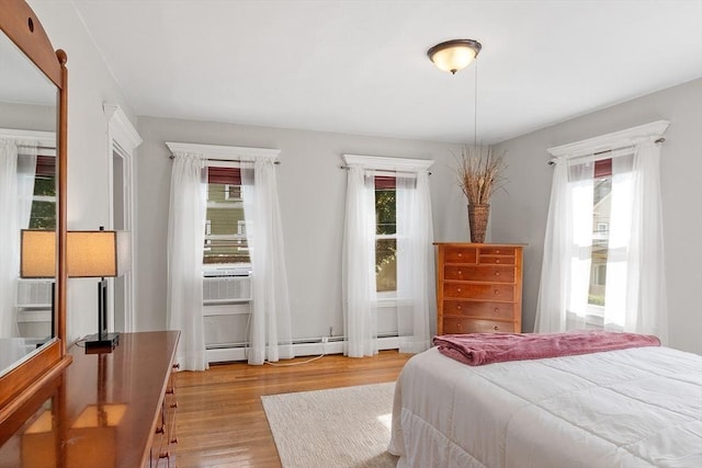 19 Franklin St, Wakefield, MA 01880 - bedroom featuring light wood finished floors, cooling unit, and a baseboard heating unit