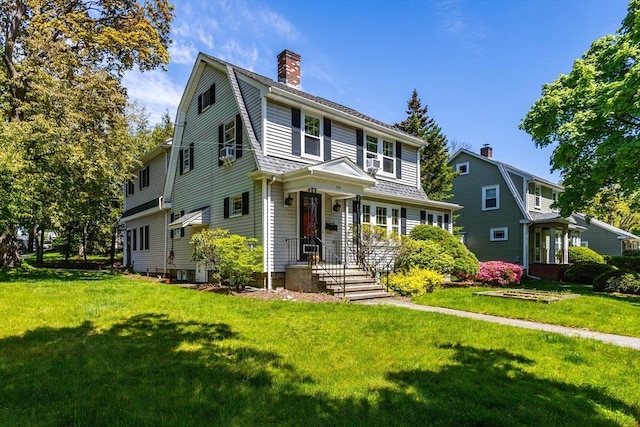 colonial inspired home featuring a front yard