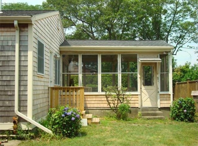 574 Florence St, Fall River, MA 02720 - rear view of property featuring a sunroom, entry steps, and a lawn