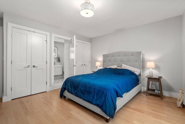 11 Cameron St Unit 1, Brookline, MA 02445 - bedroom with light wood-style flooring, multiple closets, baseboards, and ensuite bathroom