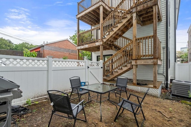 11 Cameron St Unit 1, Brookline, MA 02445 - fenced backyard featuring stairway, cooling unit, a wooden deck, and grilling area