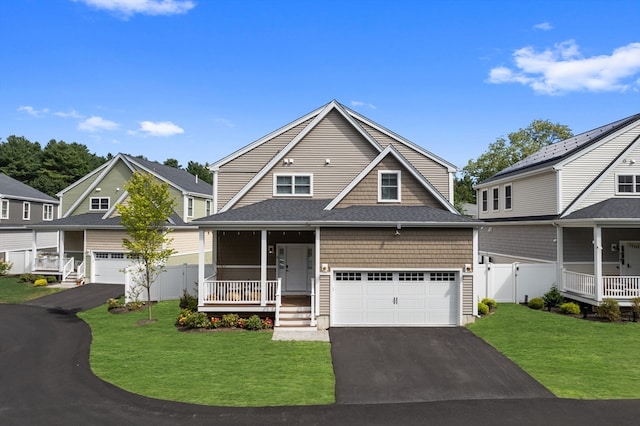 view of front facade with a porch, a garage, and a front lawn