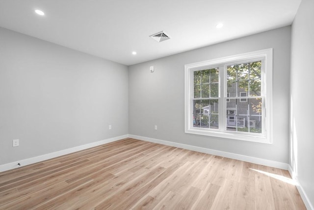 empty room with light hardwood / wood-style floors