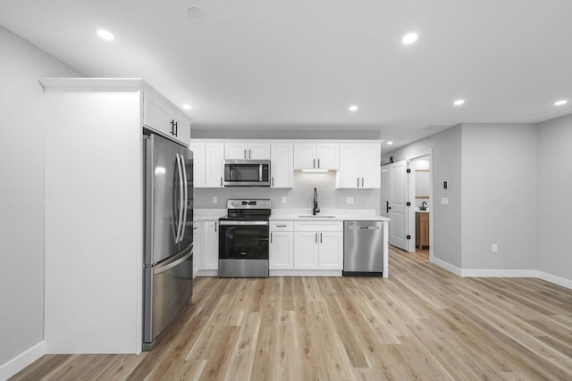 kitchen with white cabinetry, sink, and stainless steel appliances