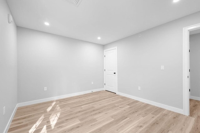 spare room with light hardwood / wood-style floors