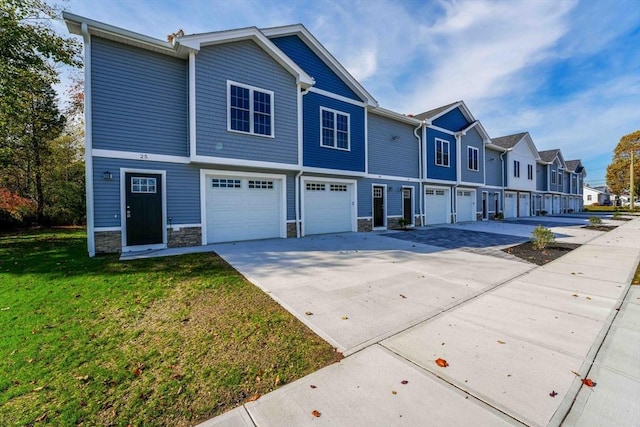 multi unit property featuring a garage and a front yard