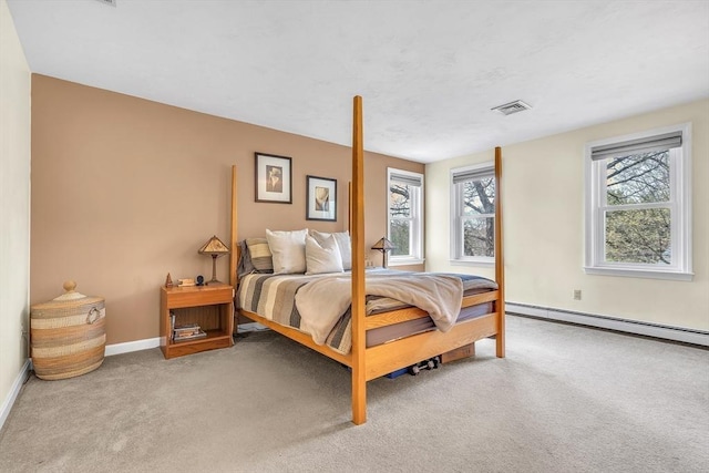 carpeted bedroom with visible vents, a baseboard radiator, and baseboards