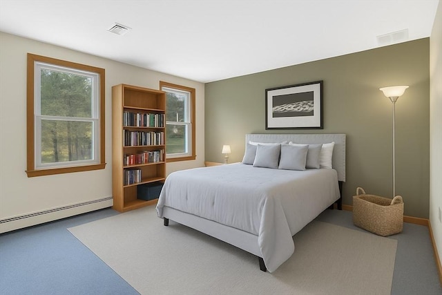 bedroom with a baseboard radiator, carpet flooring, and visible vents