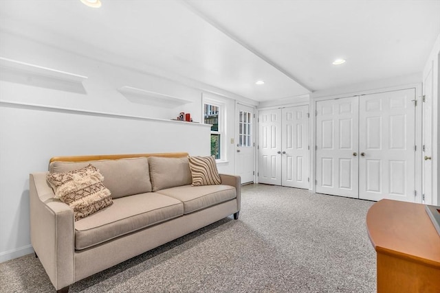 carpeted living area featuring recessed lighting and baseboards