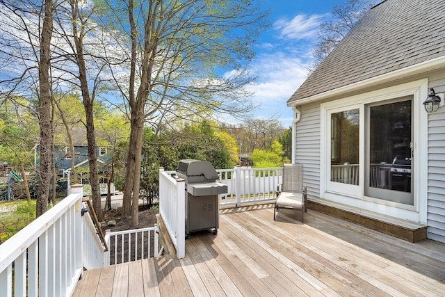 wooden deck with a grill
