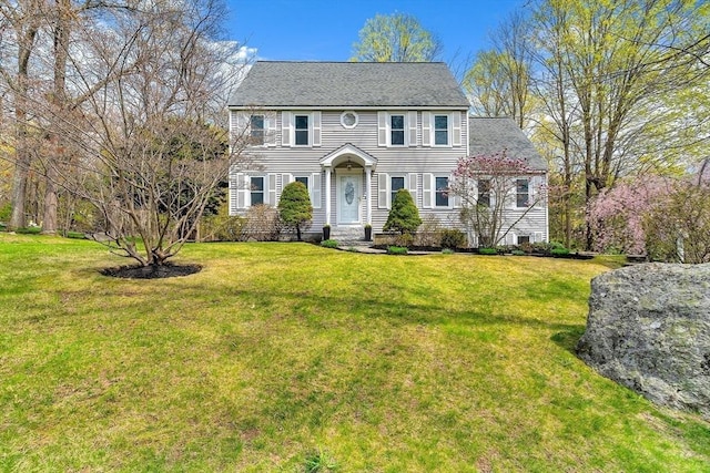 colonial-style house with a front yard